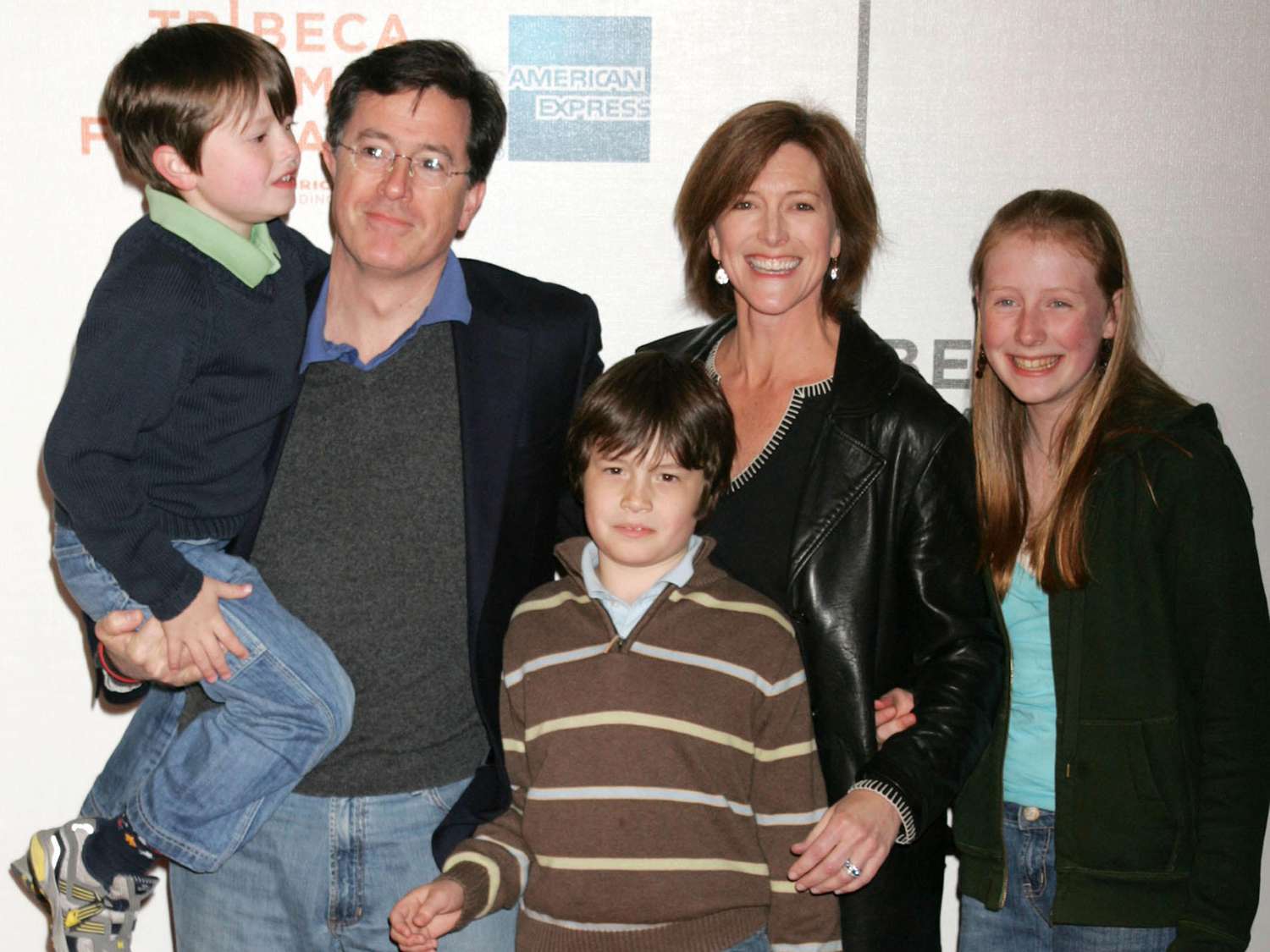 Stephen Colbert posing on the red carpet with his wife Evelyn and their three children, all dressed elegantly and smiling.