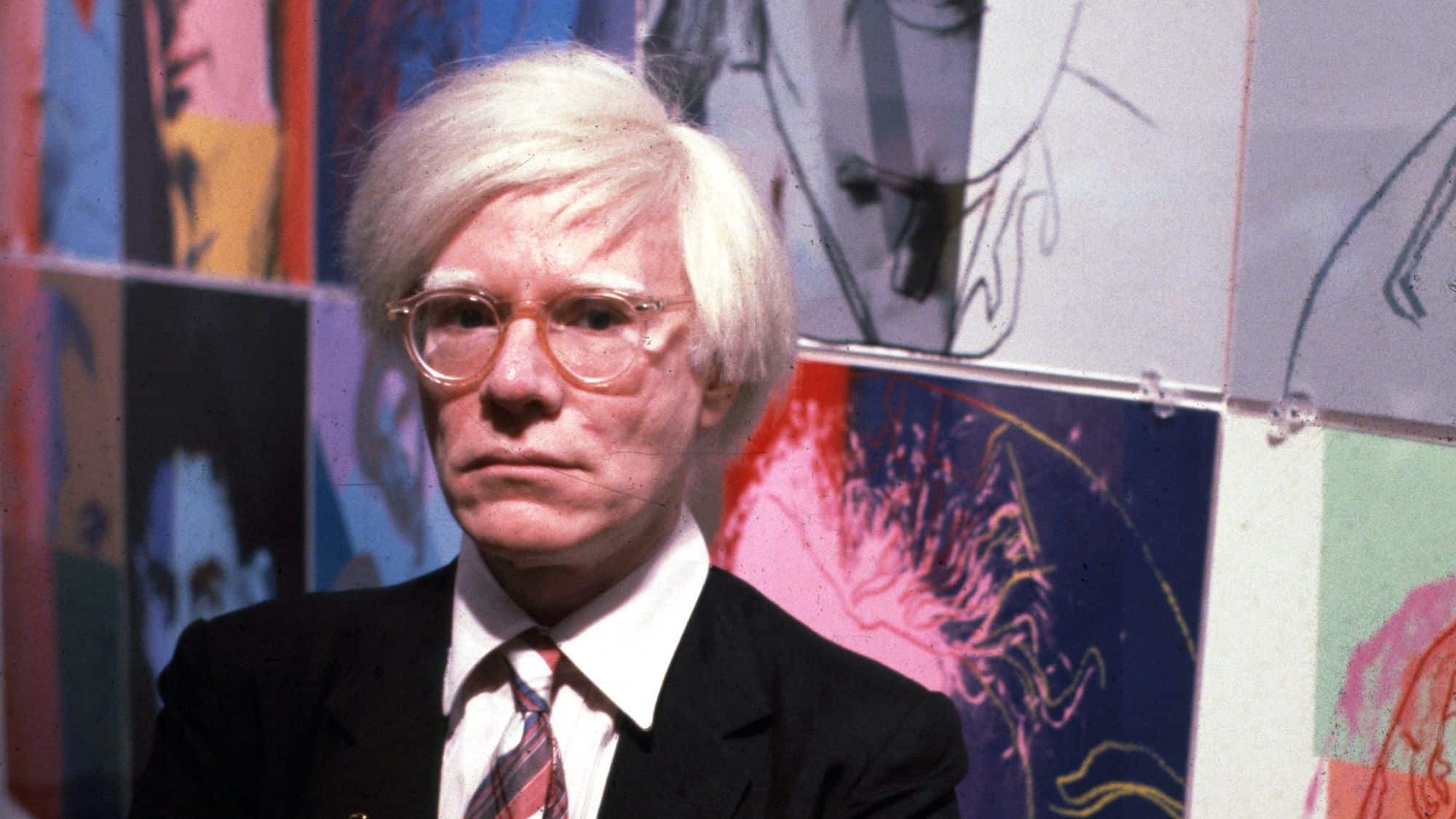 Andy Warhol portrait in silver wig with pop art style background