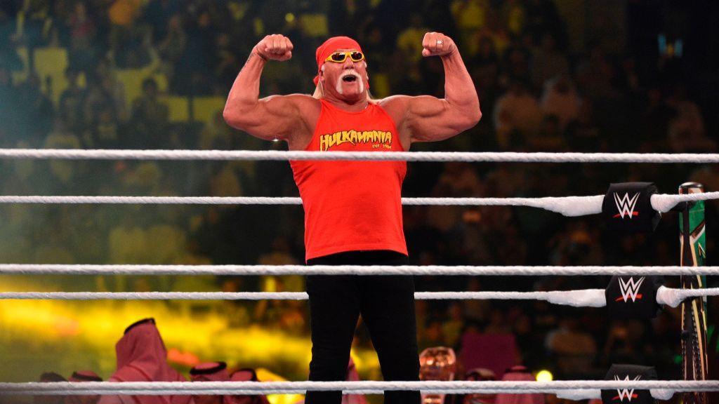 Hulk Hogan flexing his muscles powerfully in the wrestling ring, energizing the crowd.