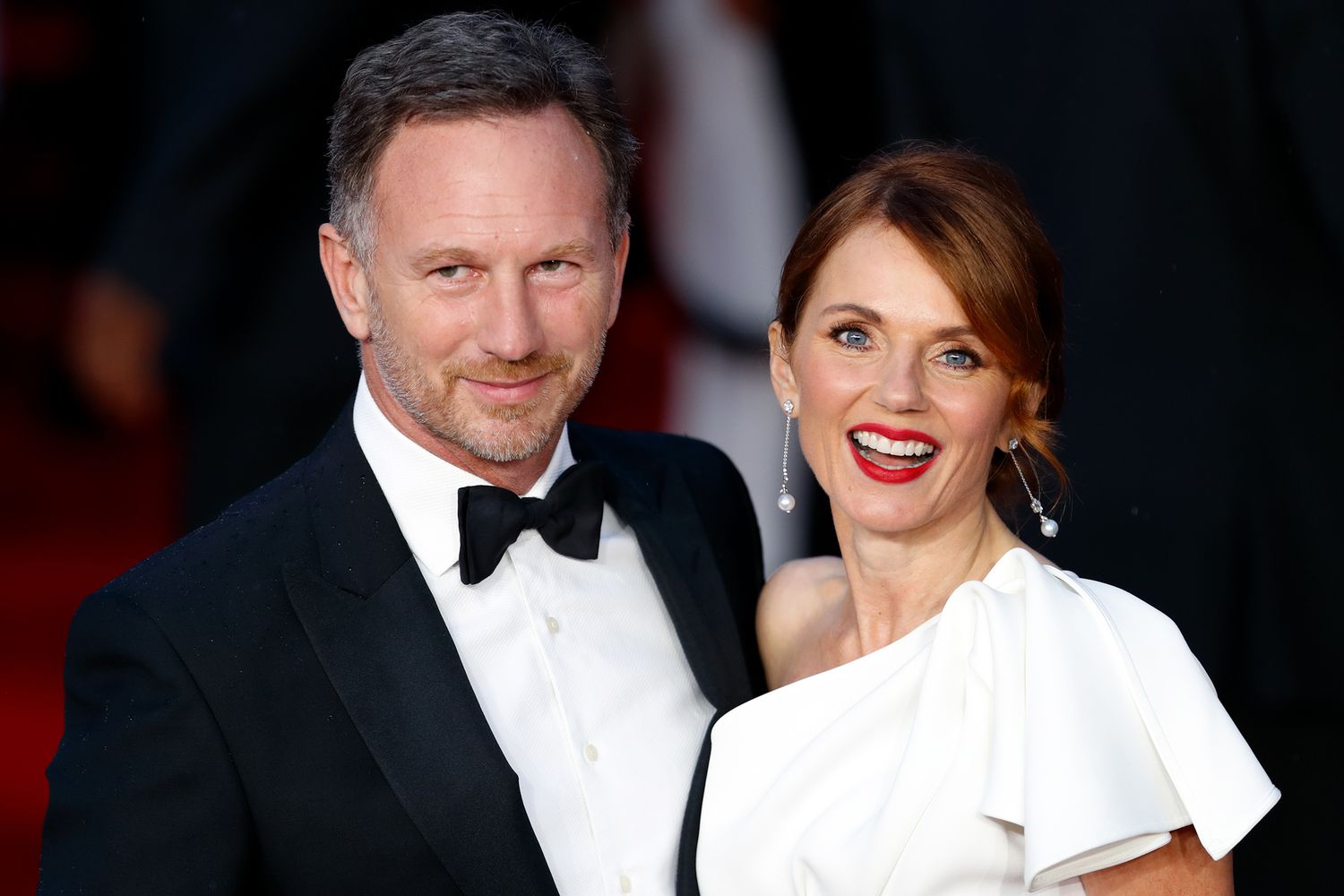 Geri Halliwell and Christian Horner posing together on the red carpet, dressed elegantly for a high-profile event.