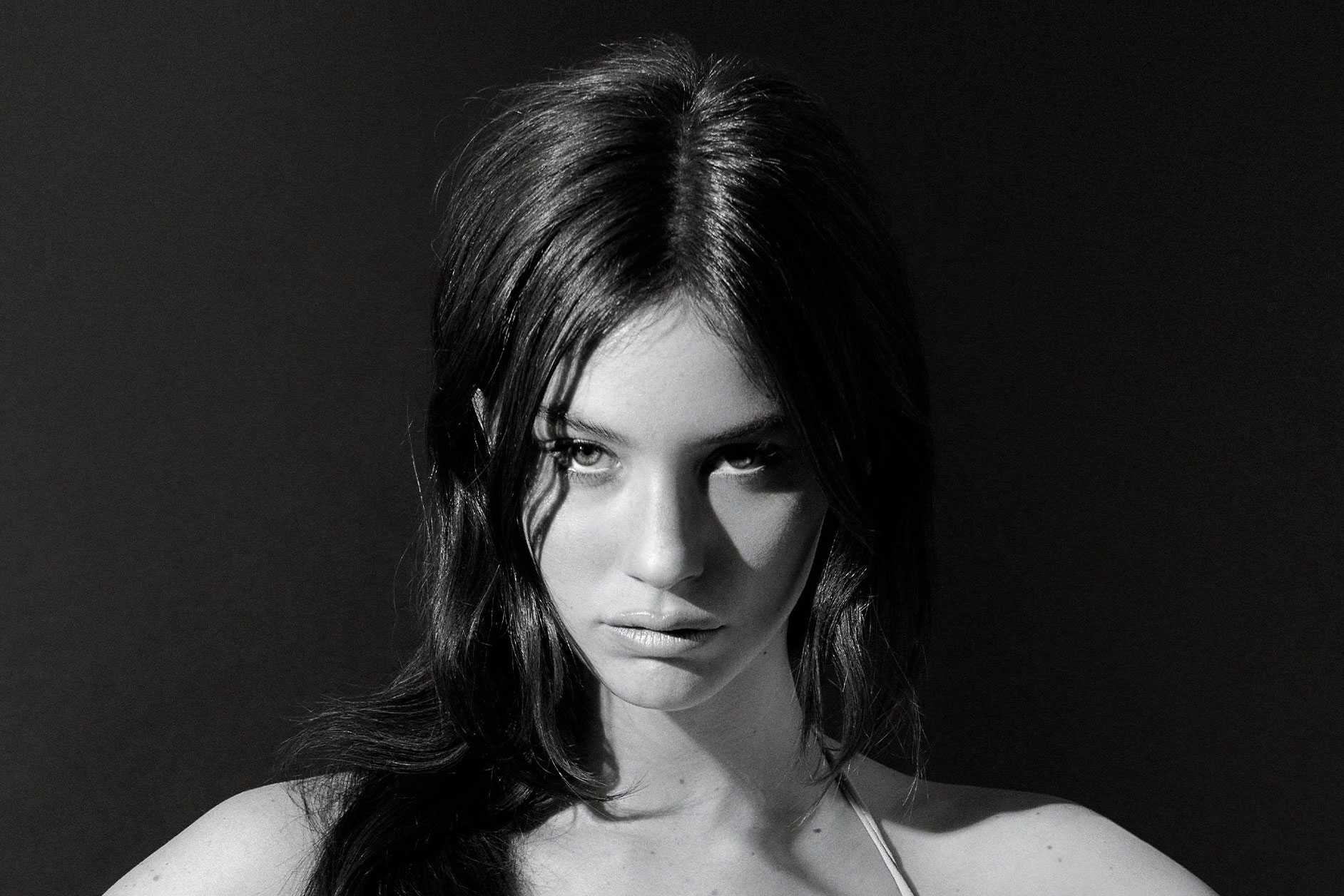 Gracie Abrams looking serious in a black-and-white photoshoot, conveying depth and artistic intensity.