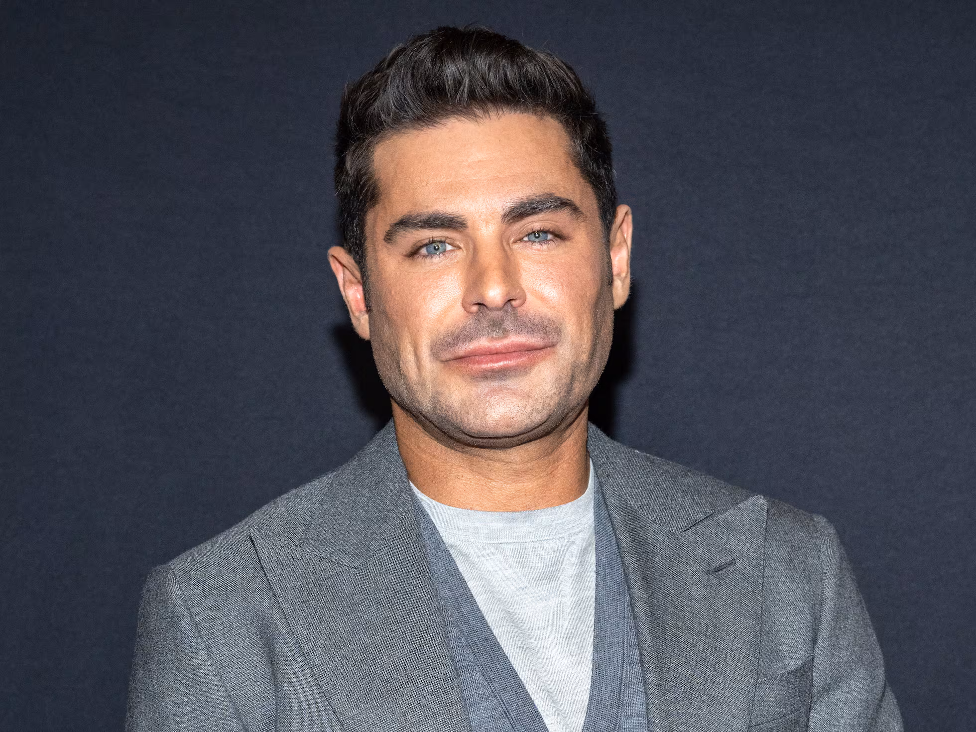 Zac Efron on the red carpet in 2025 showing noticeable changes in his facial features compared to earlier appearances.