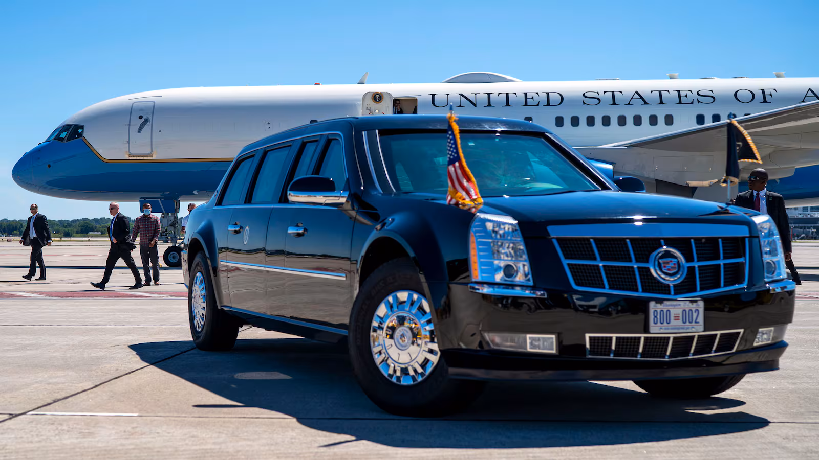 The presidential limousine known as "The Beast" parked in front of Air Force One.
