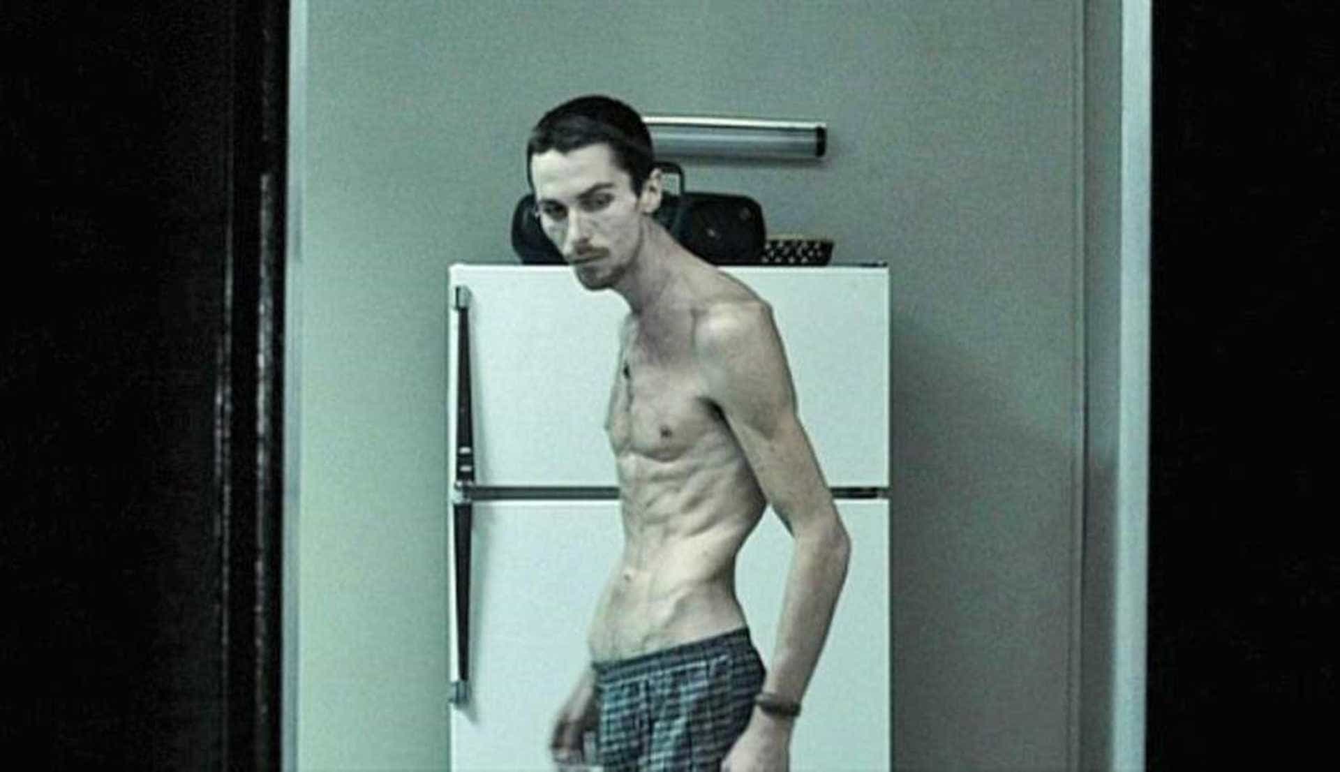 Christian Bale in The Machinist, looking gaunt and emaciated, reflecting his dramatic physical transformation for the role.