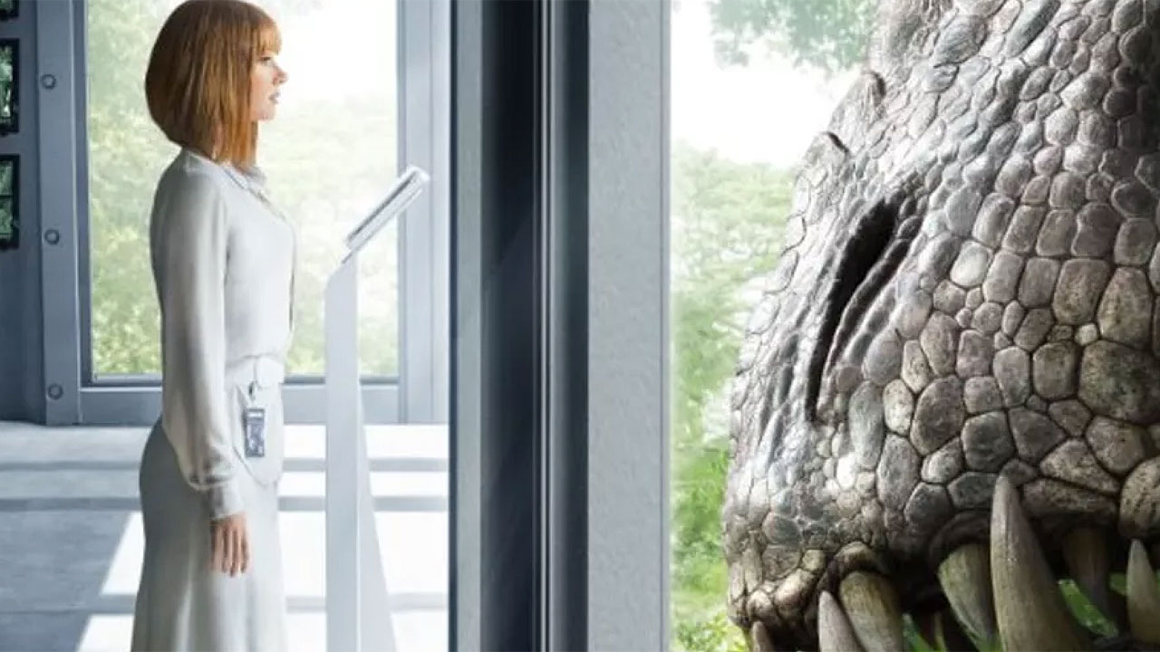 Bryce Dallas Howard standing face to face with the Indominus Rex in a tense scene from Jurassic World.