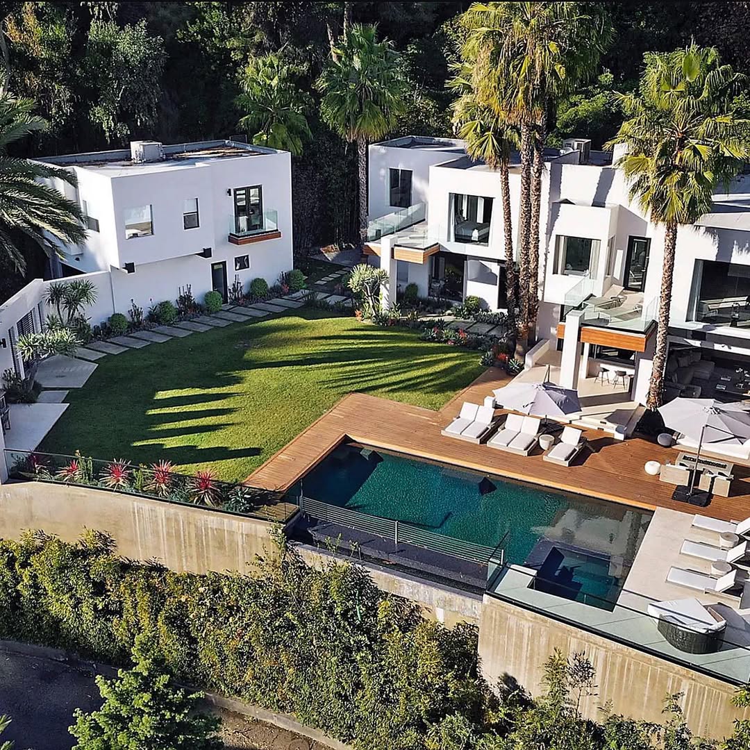 Aerial view of Bad Bunny’s $8.8 million Hollywood Hills mansion, featuring modern architecture, terraces, and panoramic city and canyon views.