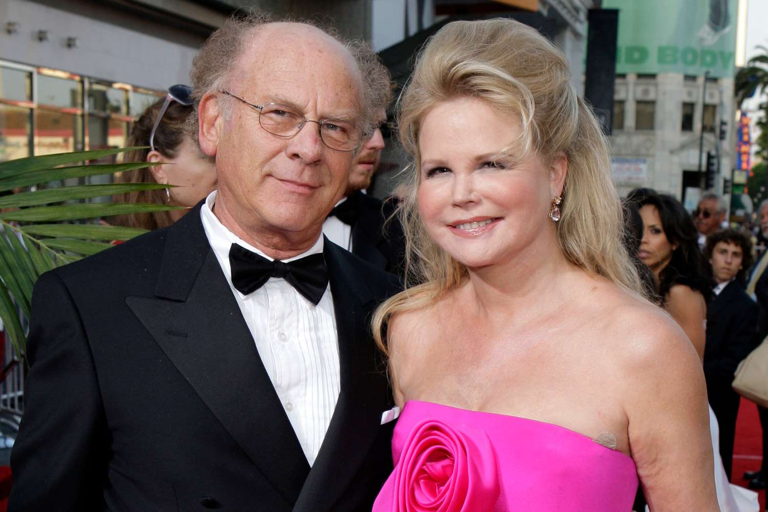 Art Garfunkel and his wife posing together on the red carpet, dressed elegantly for a formal event.