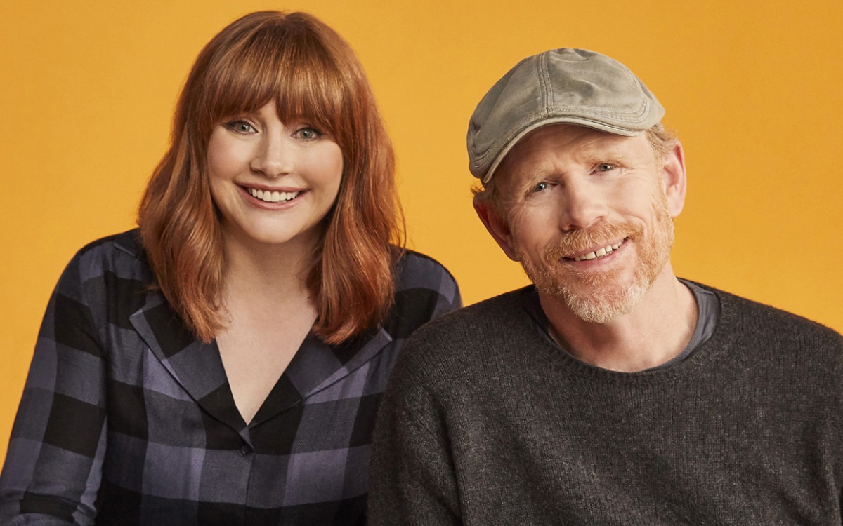 Bryce Dallas Howard smiling alongside her father Ron Howard at a public event.