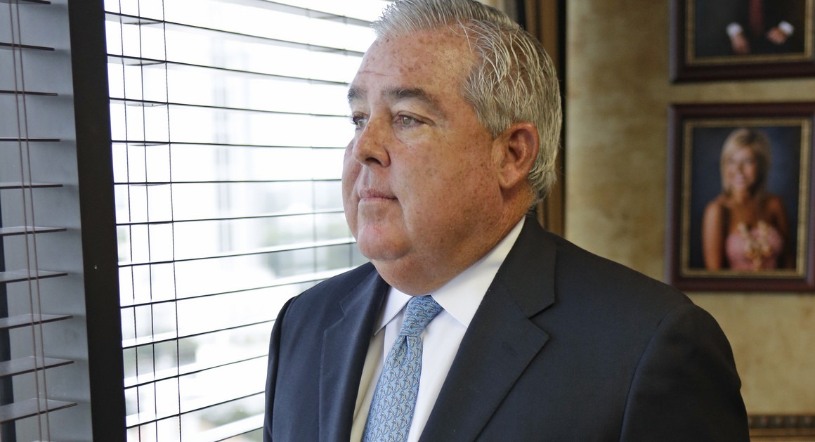 John Morgan looking thoughtfully out the window of his Florida office.