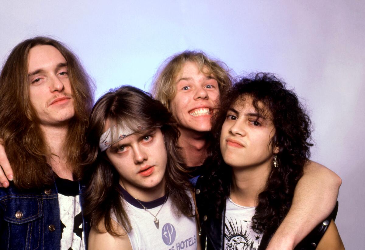 Young Metallica band posing for the camera during their early years.