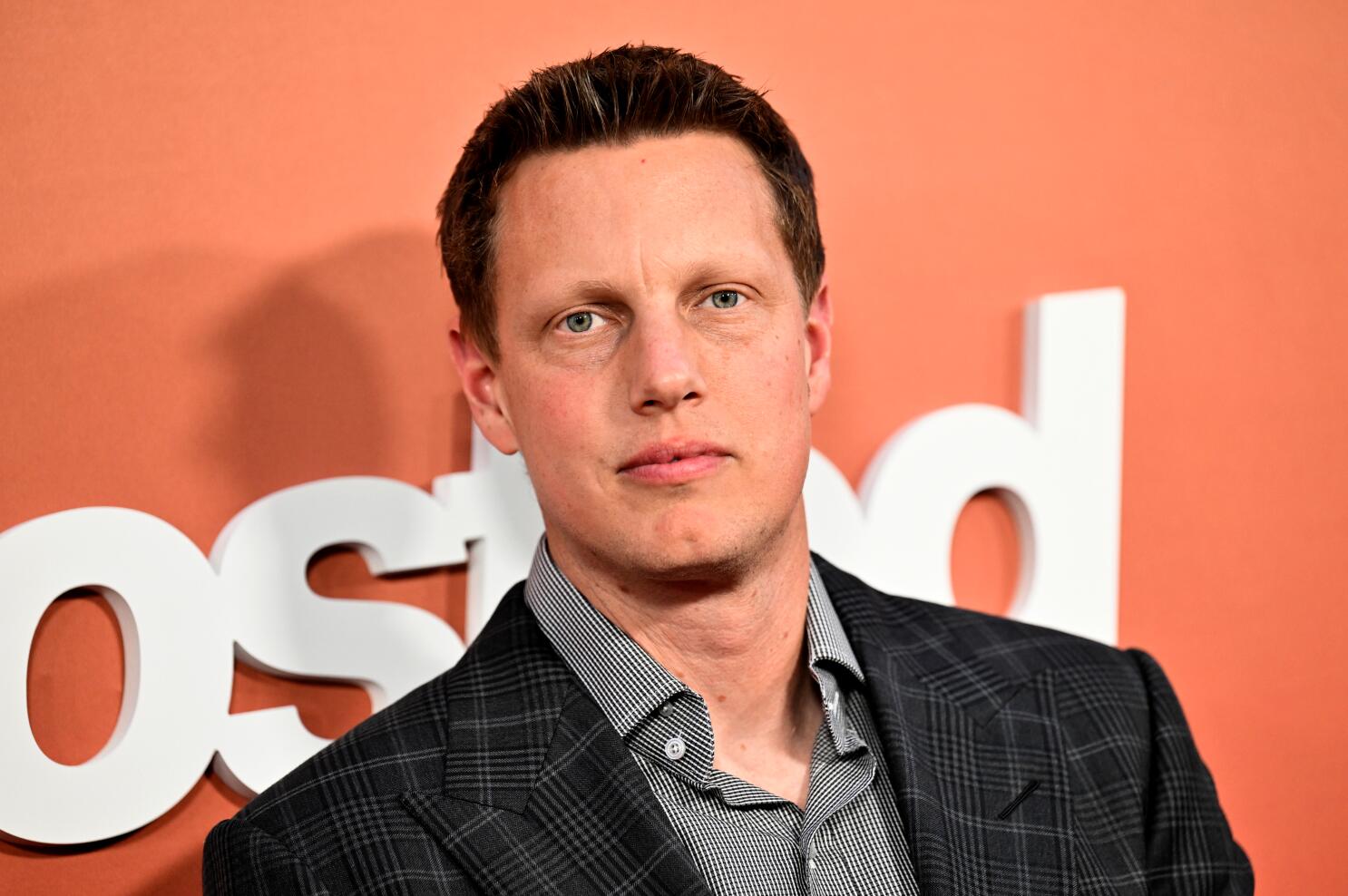 David Ellison posing confidently for the camera at the premiere of Ghosted.