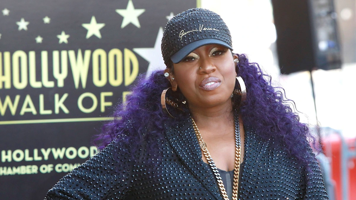 Missy Elliott posing on the Hollywood Walk of Fame red carpet, smiling proudly beside her newly unveiled star.