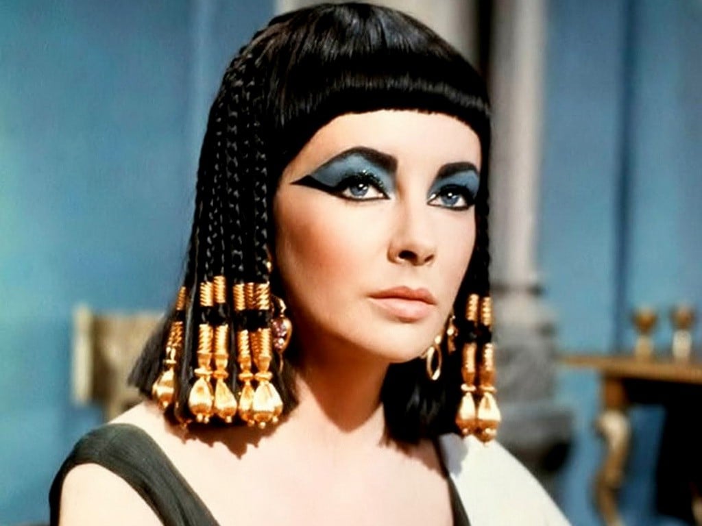 Elizabeth Taylor as Cleopatra in the iconic gold and jeweled costume from the 1963 film.