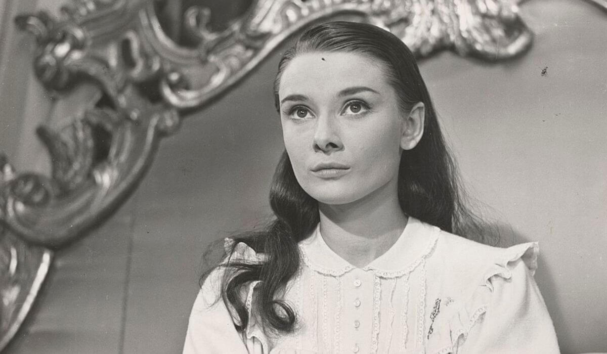Audrey Hepburn looking serious and focused during a dramatic scene in a film.
