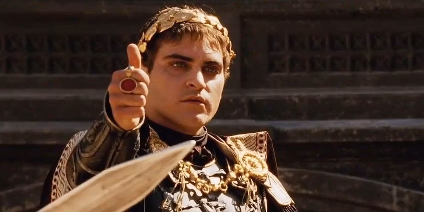 Joaquin Phoenix as Commodus in Gladiator, wearing Roman armor with a serious and commanding expression.