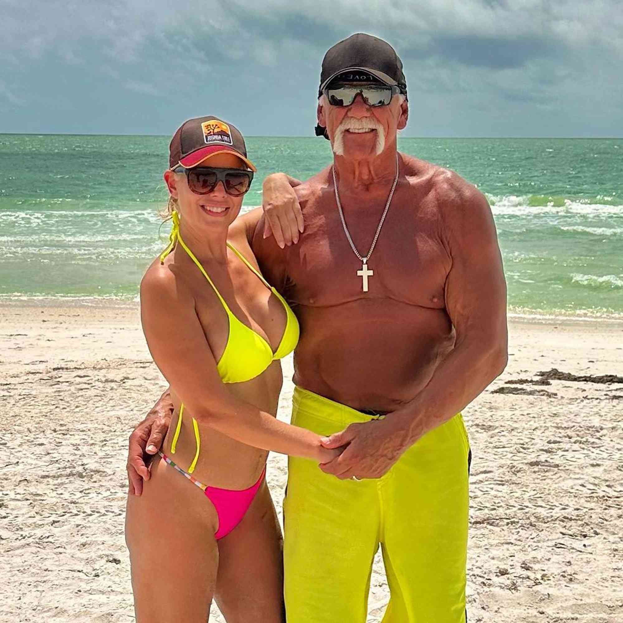 Hulk Hogan and his wife Sky Daily smiling together on a sunny beach, enjoying a peaceful moment.