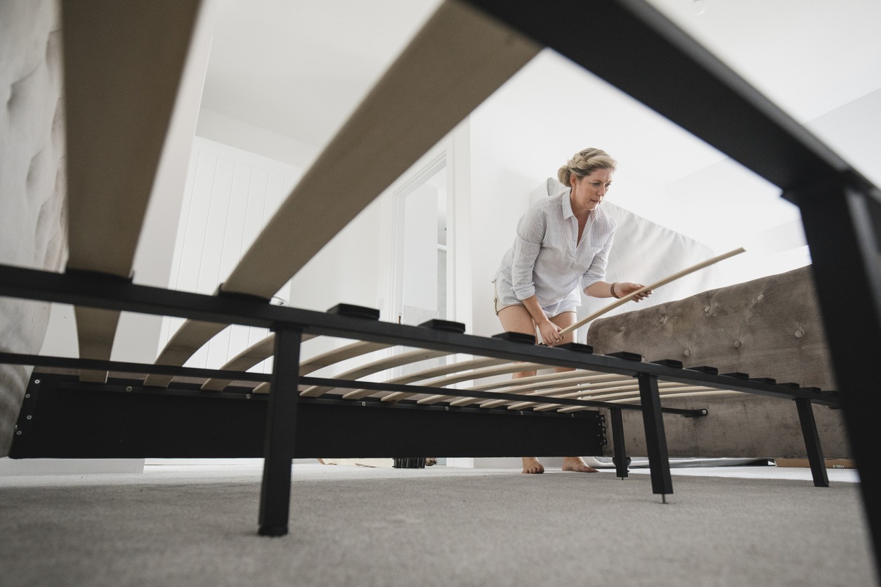 mature woman building bed in new home