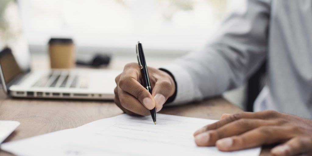 business man signing document, hand holding pen putting signature at paper