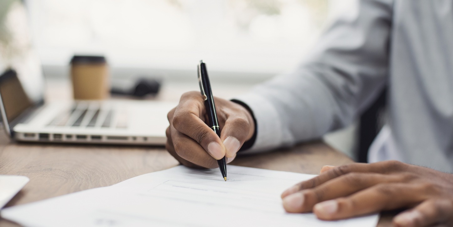 business man signing document, hand holding pen putting signature at paper