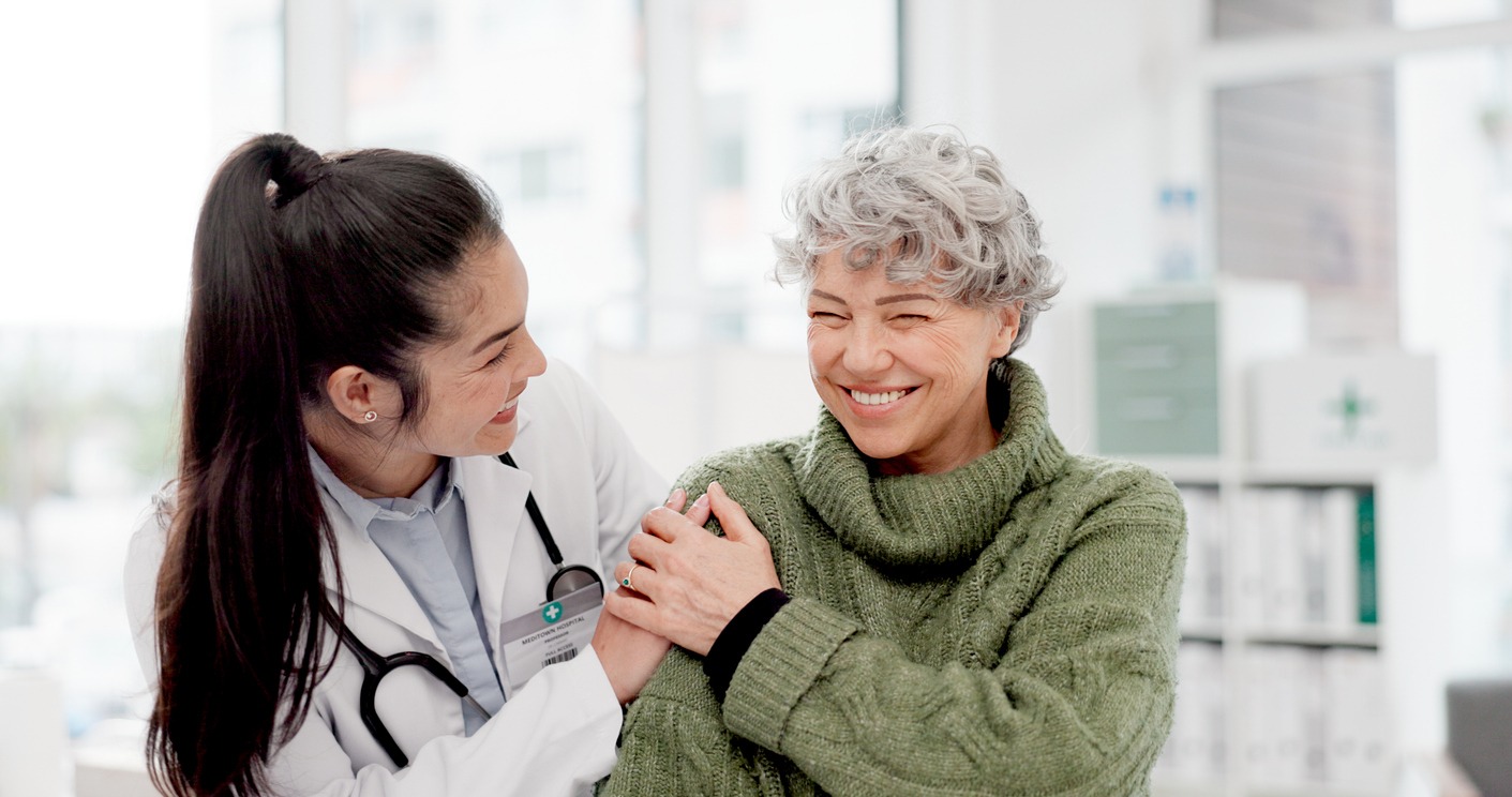 happy, care and face of a doctor with a woman for medical trust, healthcare and help. laughing, hug and portrait of a young nurse with a senior patient and love during a consultation at a clinic
