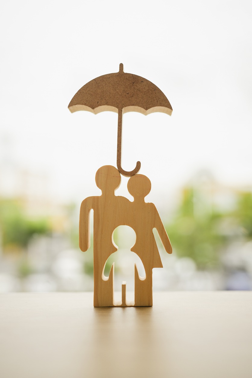 umbrella icon and family model, security protection and health insurance. the concept of family home, protection, health care day, car insurance.