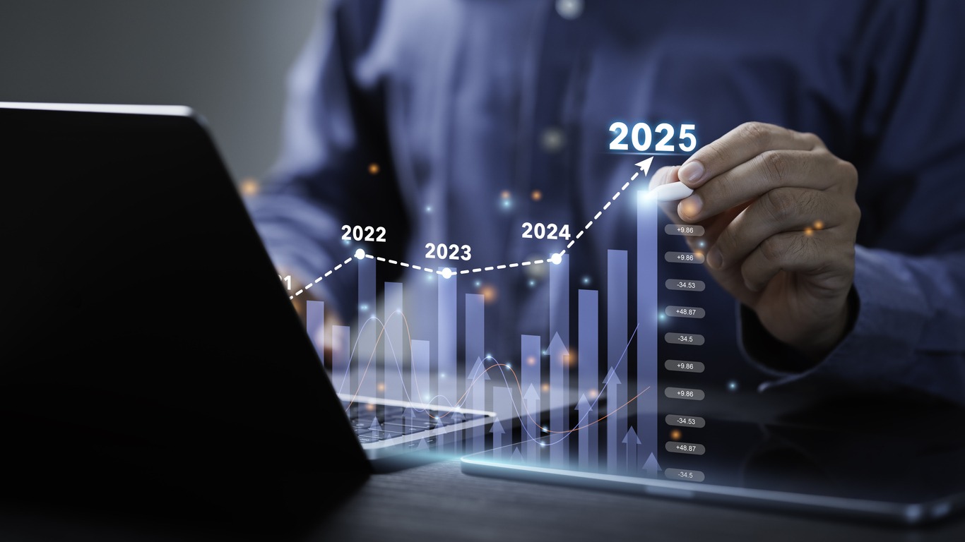 businessman analyzes the graph of trend market growth in 2025 and plans business growth and profit increase in the year 2025. plan finances of the business