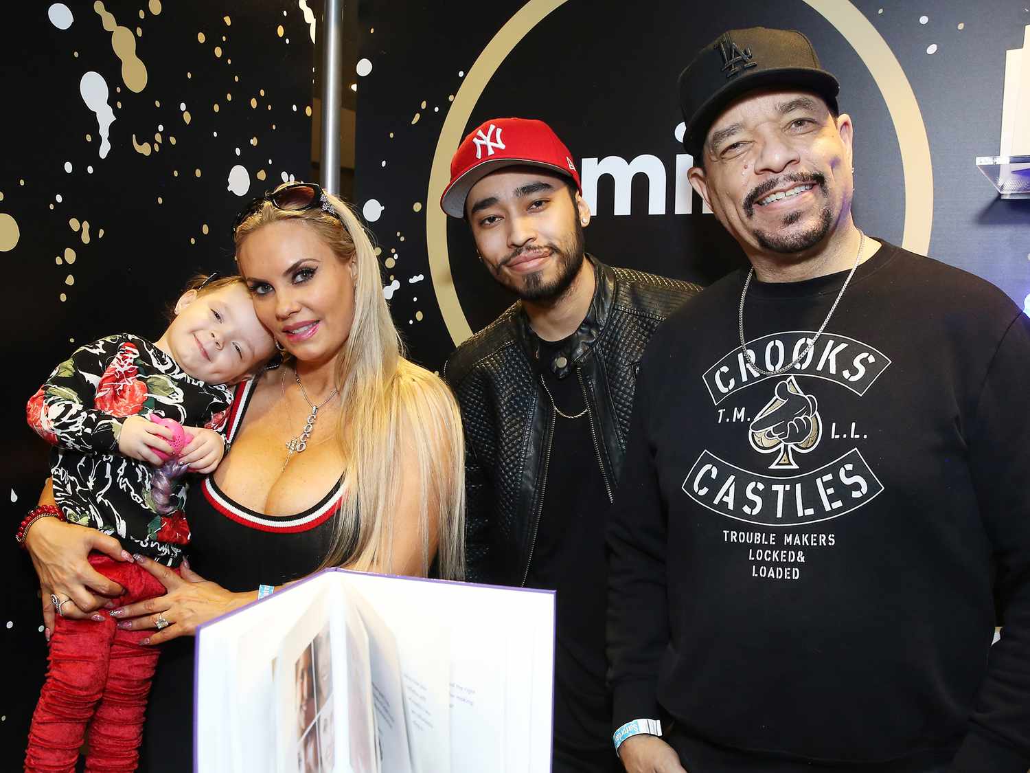 Ice-T posing with his wife Coco Austin and daughter Chanel at a public event, all dressed in coordinated outfits.