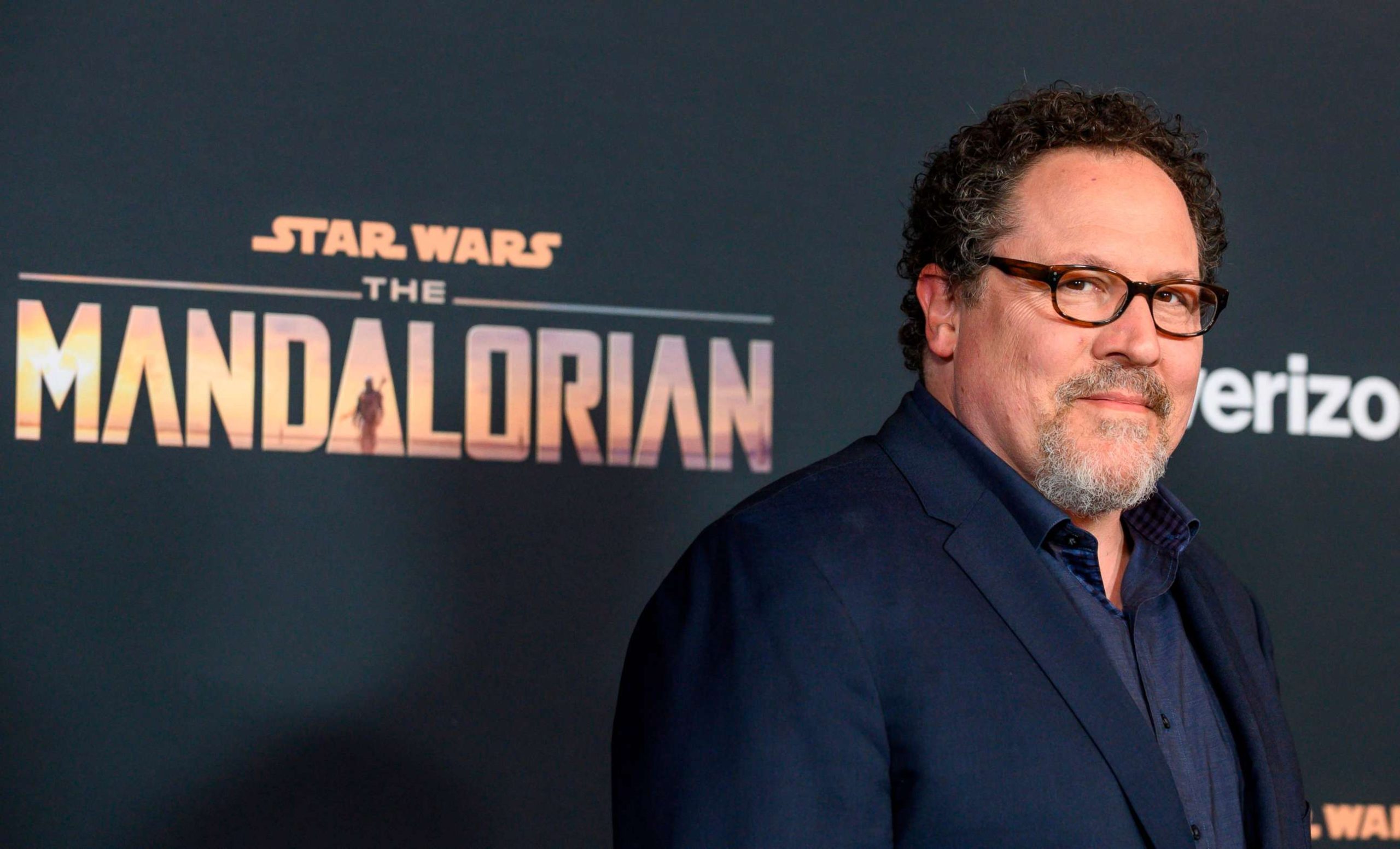 Jon Favreau smiling at the The Mandalorian premiere event.
