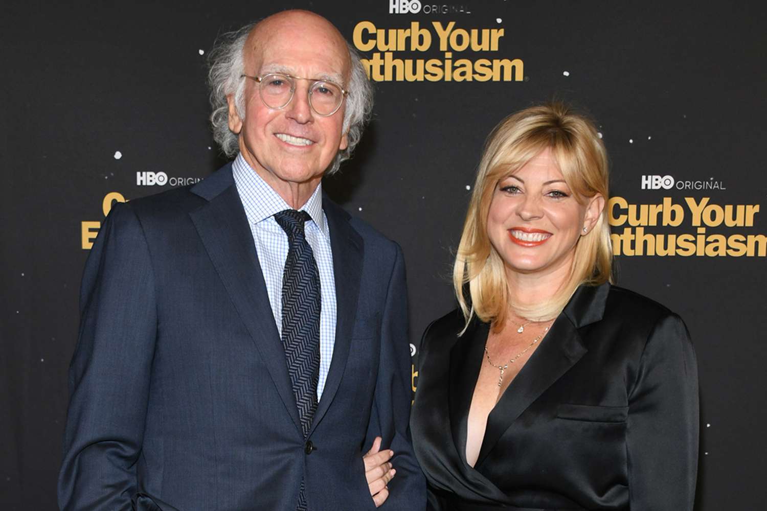 Larry David and his wife Ashley Underwood smiling together at a public event.