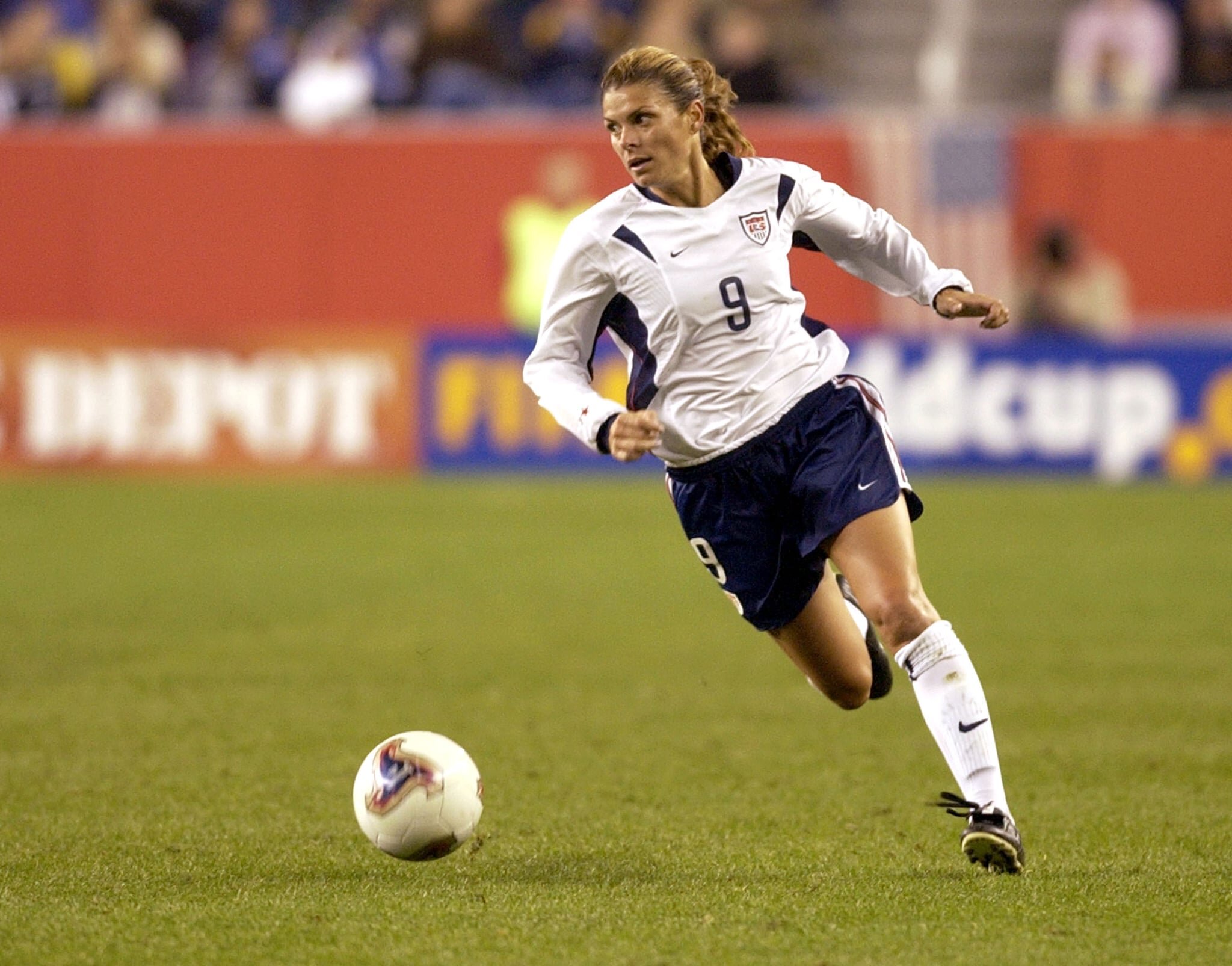 Mia Hamm running to the goal goal during a USA Women’s National Soccer Team match.