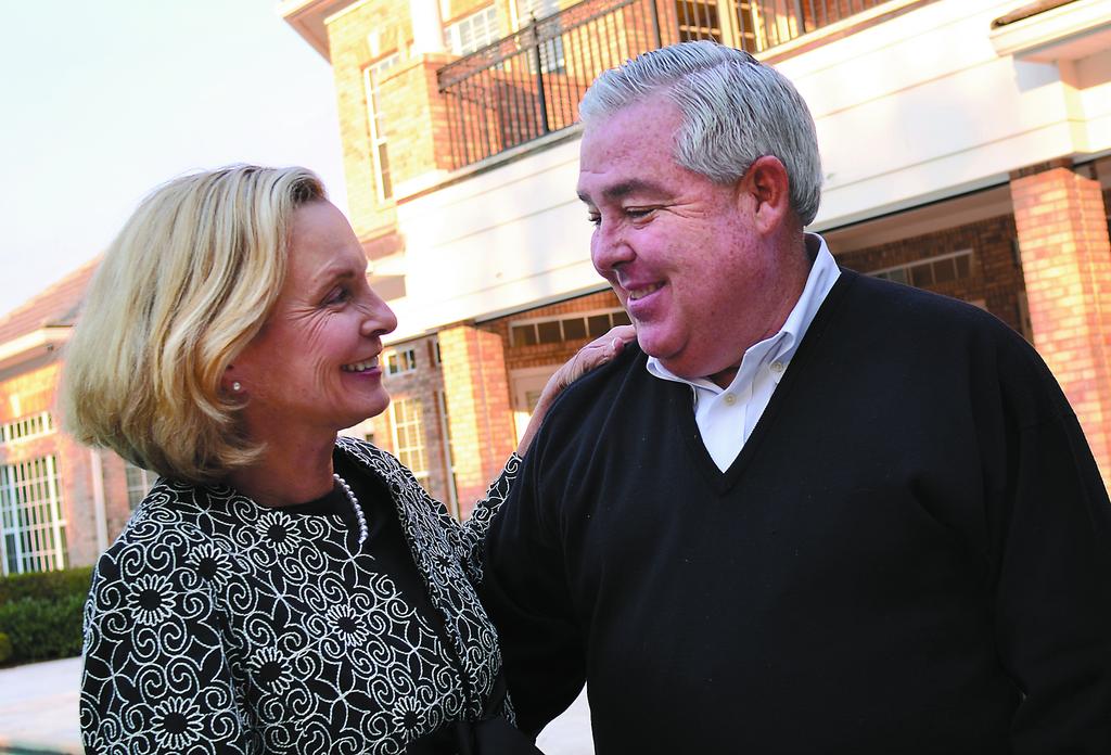 John Morgan and his wife gazing lovingly into each other’s eyes at a formal event.