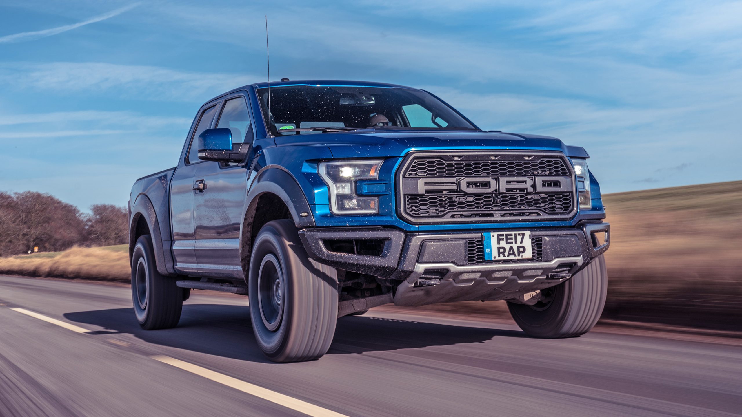 A Ford F-150 Raptor pickup truck parked outdoors, showcasing its rugged design and off-road capabilities.
