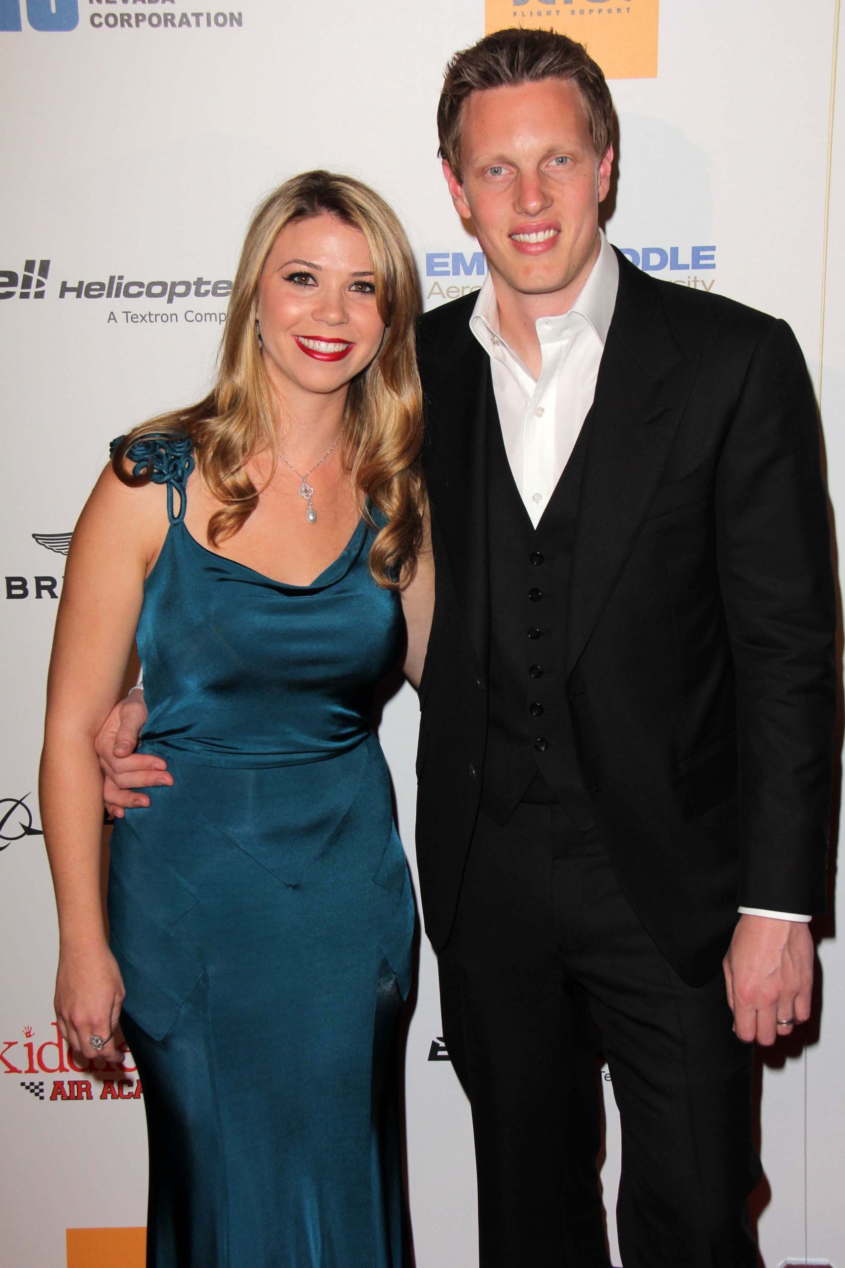 David Ellison and his wife Sandra Lynn smiling together on the red carpet at a formal event.