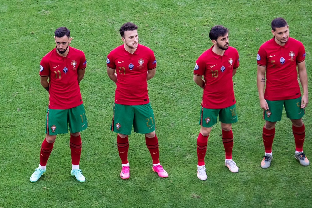 Diogo Jota standing with Portugal teammates in their national kits before a football match.