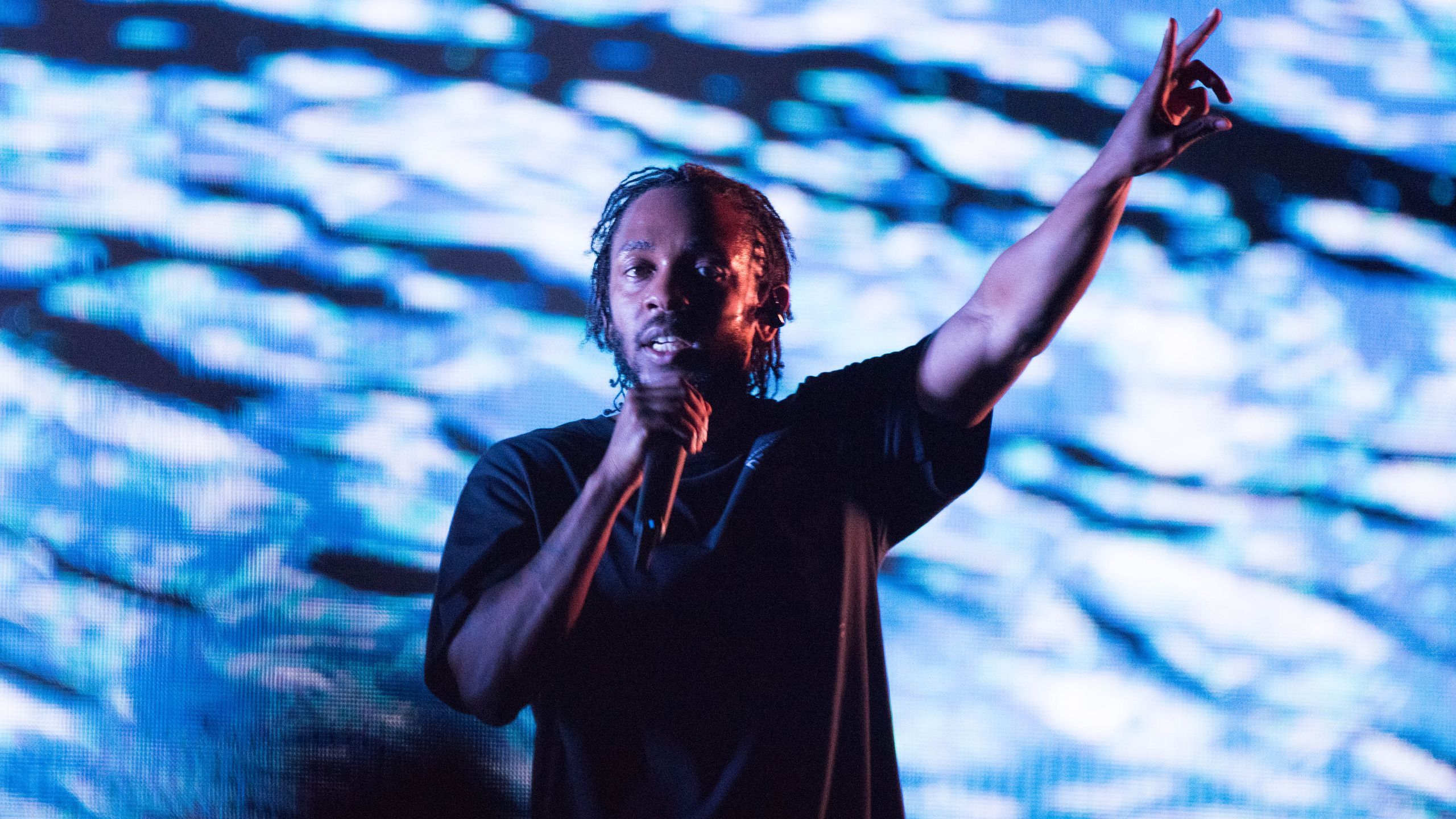Kendrick Lamar performing on stage, delivering an intense and powerful live show.