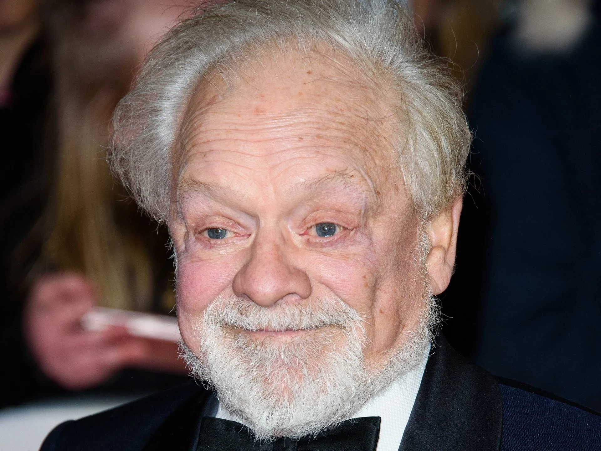 Portrait of Sir David Jason with white hair and beard, wearing a black tuxedo at a public event.