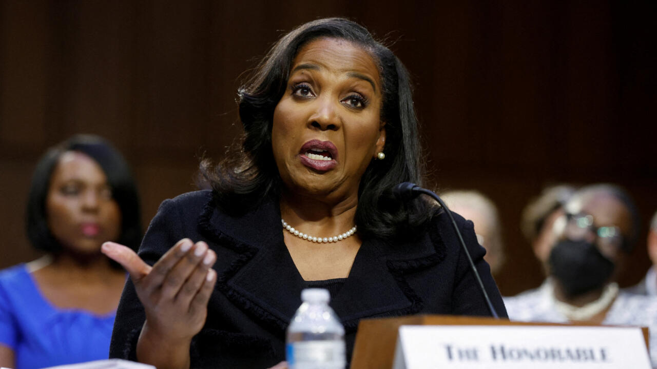 Lisa Cook speaking into a microphone during a congressional hearing.