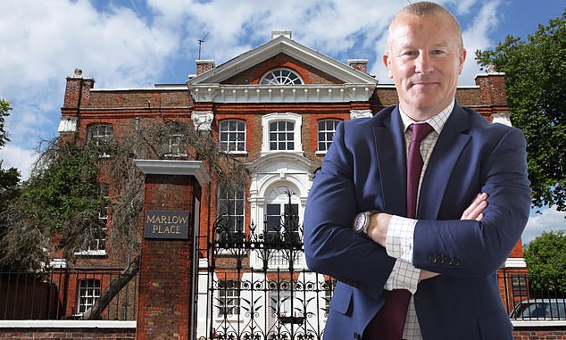 Neil Woodford standing outside Marlow House office building in London, wearing a suit and looking thoughtful.