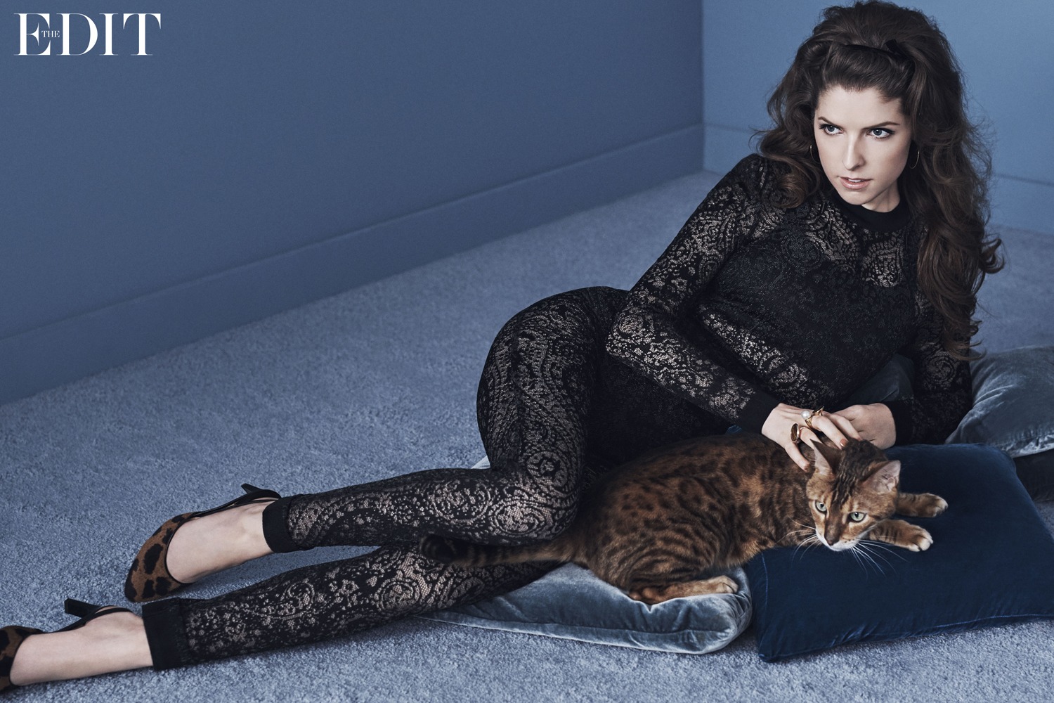 Anna Kendrick posing while lying down for a photoshoot.