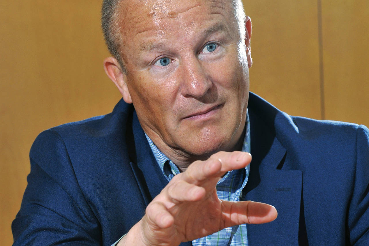 Neil Woodford gesturing with his hands during an interview, expressing emphasis and engagement.