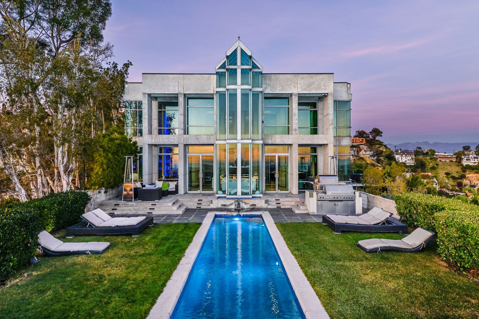 Exterior view of Rihanna’s luxurious Los Angeles mansion, featuring modern architecture, landscaped gardens, and a private driveway.