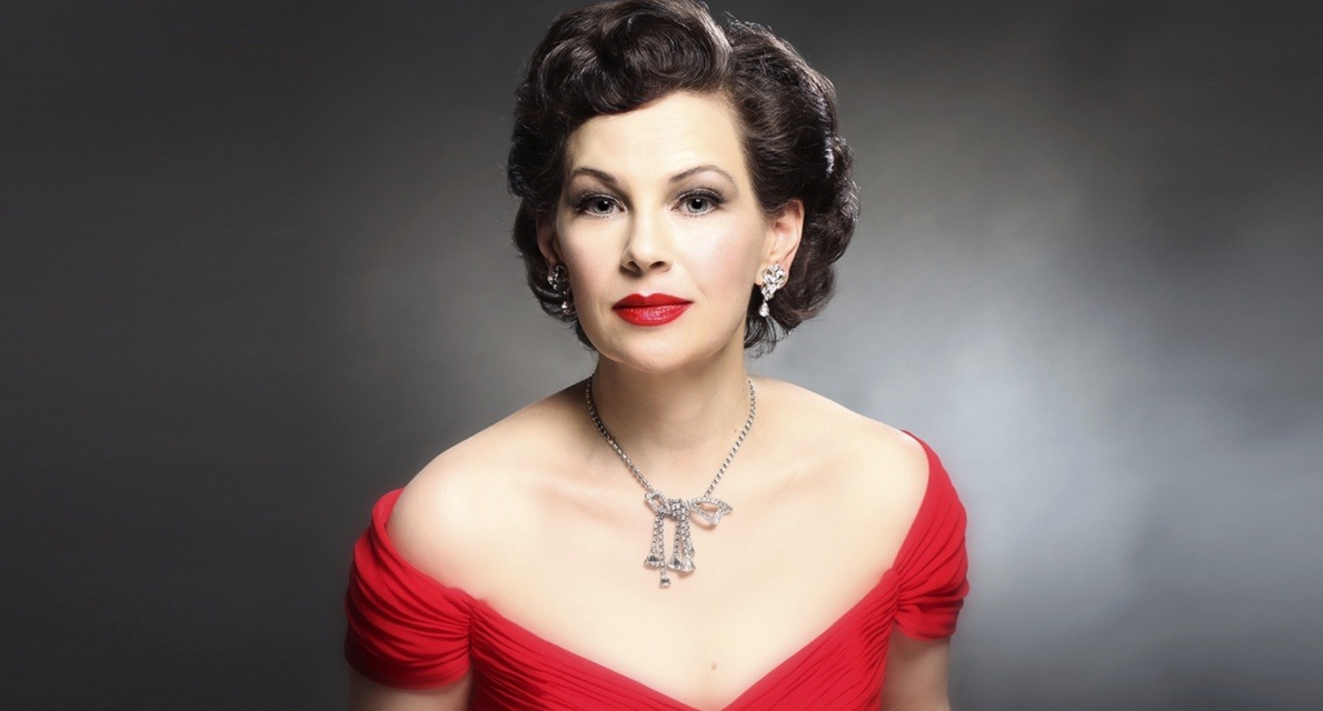 Judy Garland wearing a red dress and luxurious jewelry, exuding classic Hollywood glamour.