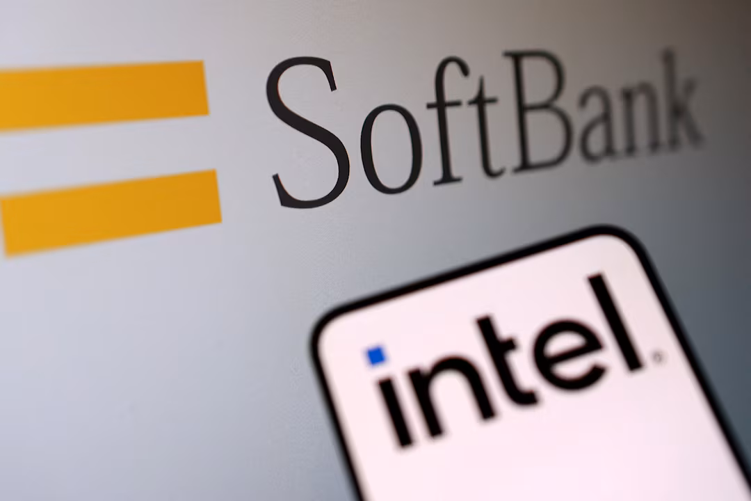 The SoftBank logo on a building with a smartphone in the foreground displaying the Intel logo on its screen.