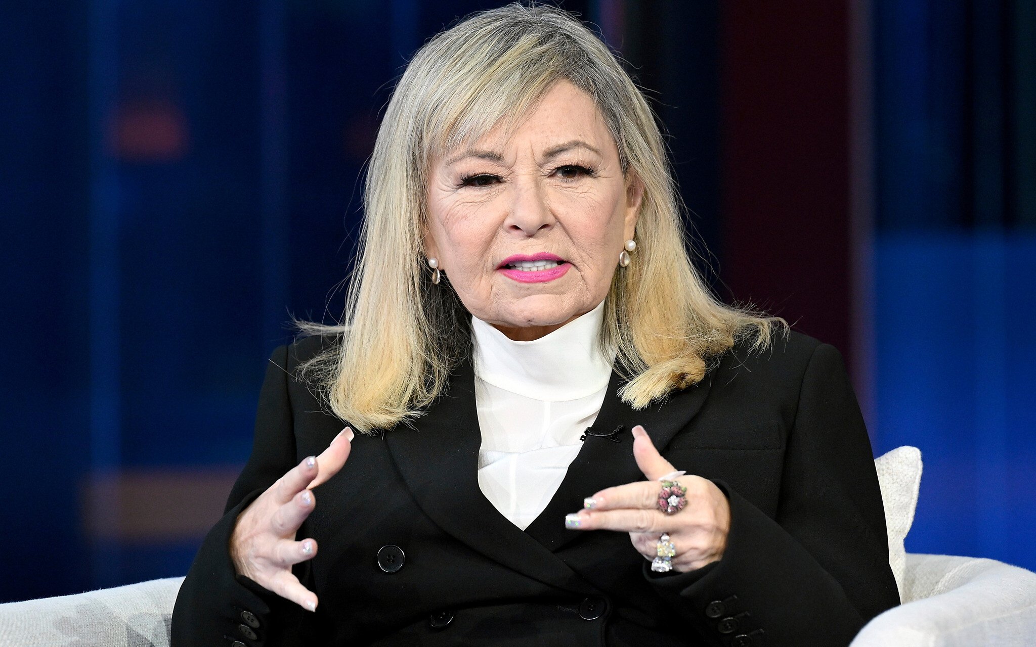 Roseanne Barr speaking during a television talk show interview.