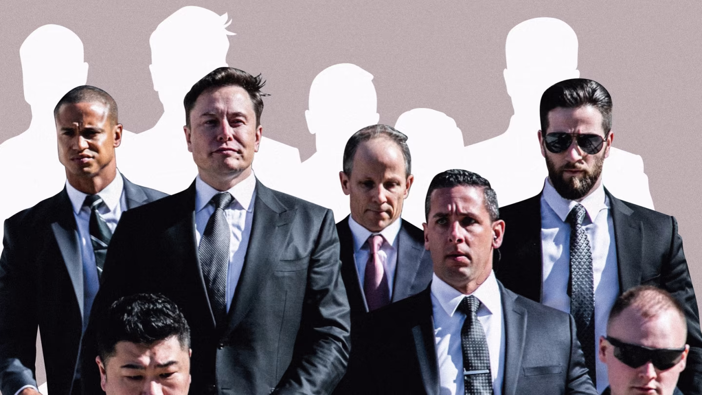 Elon Musk walking with a team of suited bodyguards, all wearing serious expressions, conveying tight personal security.