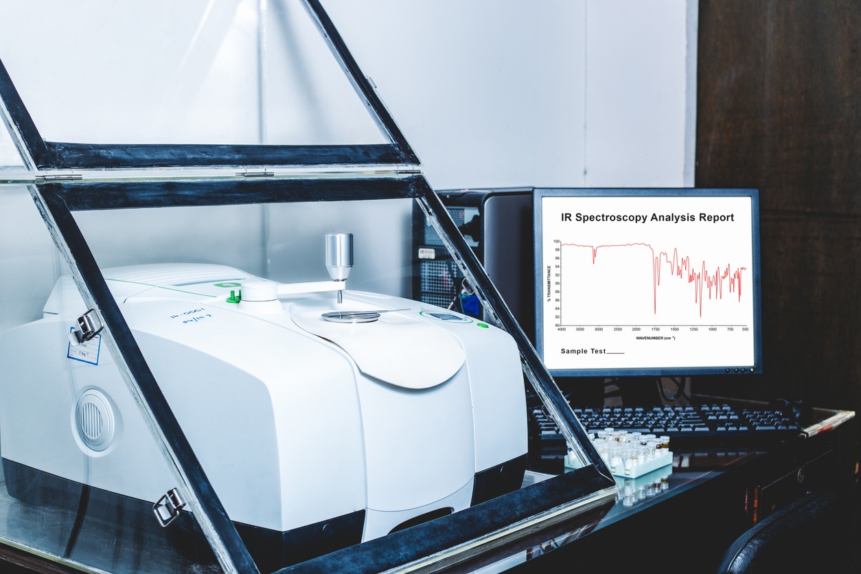fourier transform infrared spectroscopy ftir instrument and ir spectrum shown on monitor.