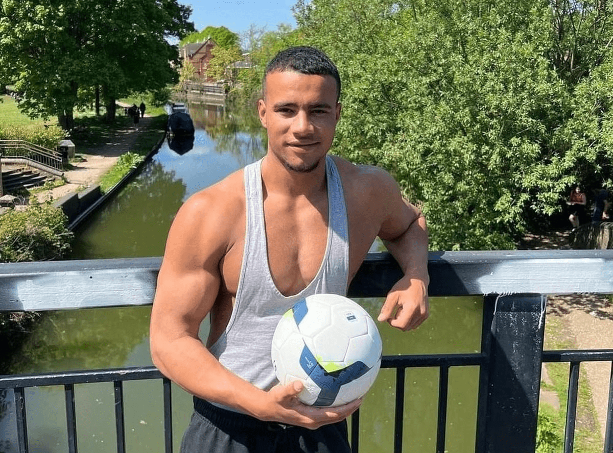 HSTikkyTokky posing with a football during a casual outdoor shoot, highlighting his fitness influencer persona.