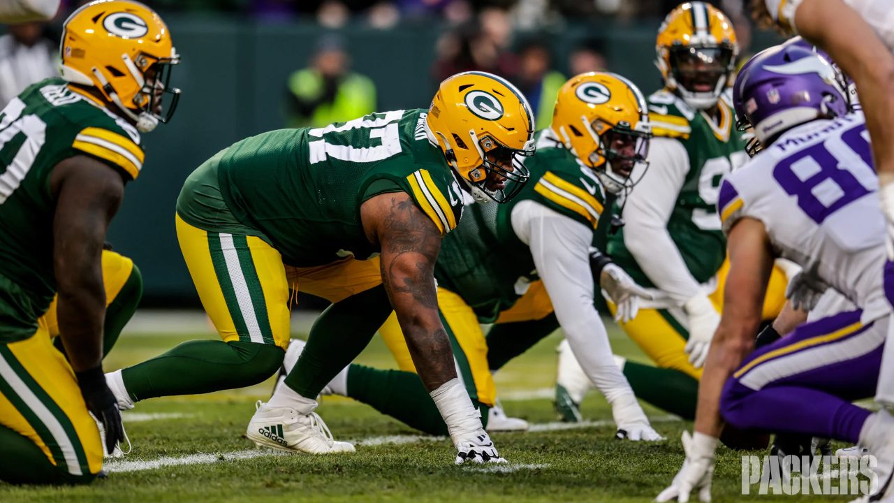 Kenny Clark lined up on the defensive line during an NFL game, ready to engage at the snap.
