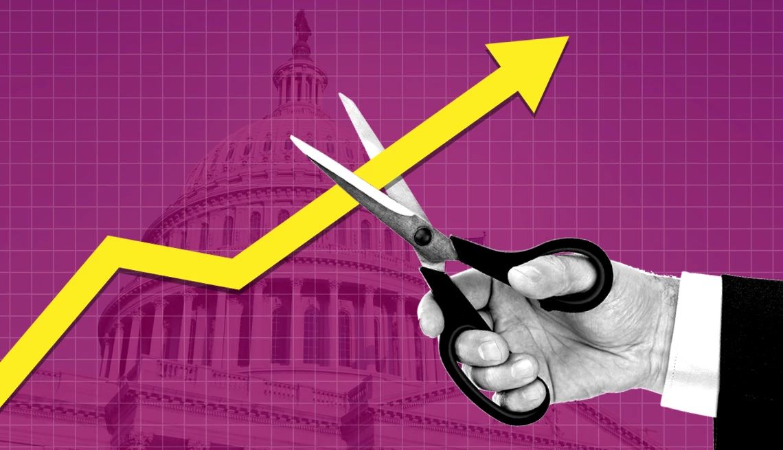 A hand cutting through an upward-pointing arrow, symbolizing the Federal Reserve’s decision to cut interest rates in 2025.