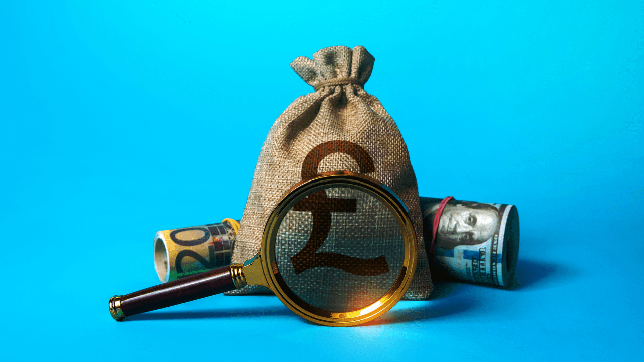A money sack and cash with a magnifying glass highlighting financial analysis.